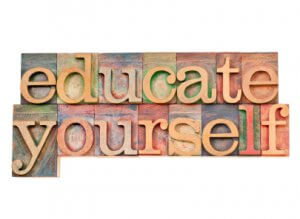 educate yourself - personal development concept - isolated text in vintage wood letterpress printing blocks stained by color inks